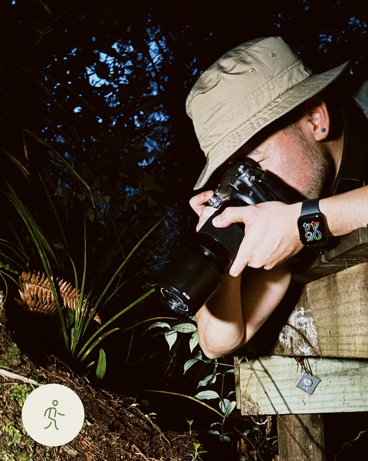 Photographer working in the forest at dusk